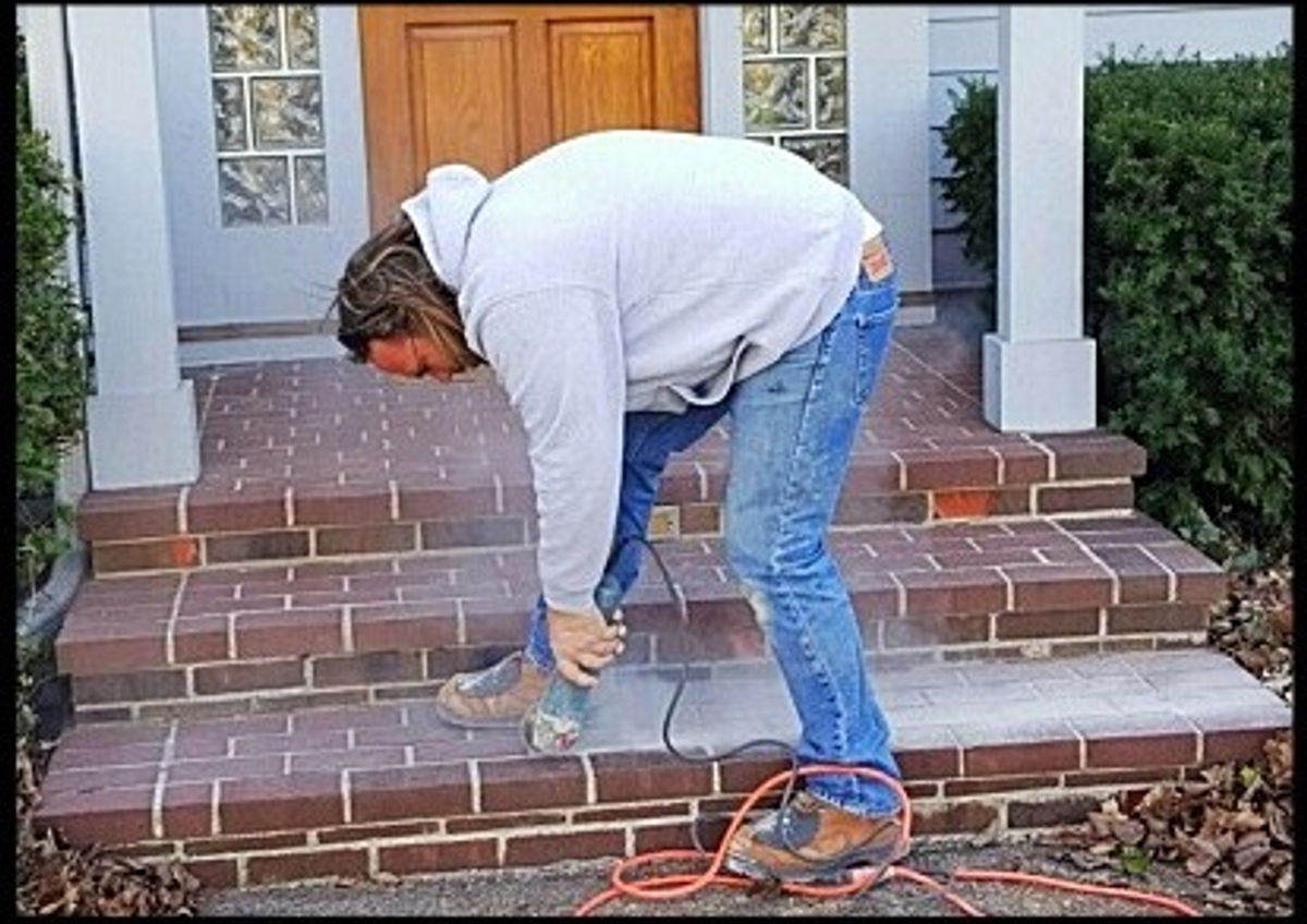 Lone Wolf mason laying brick steps on a Central Indiana home