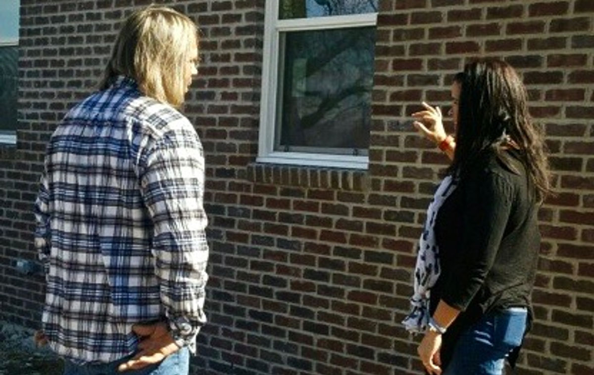 Tim Phipps discussing a brick wall project with a customer