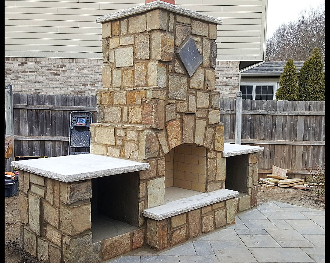 Outdoor stone fireplace and paver patio
