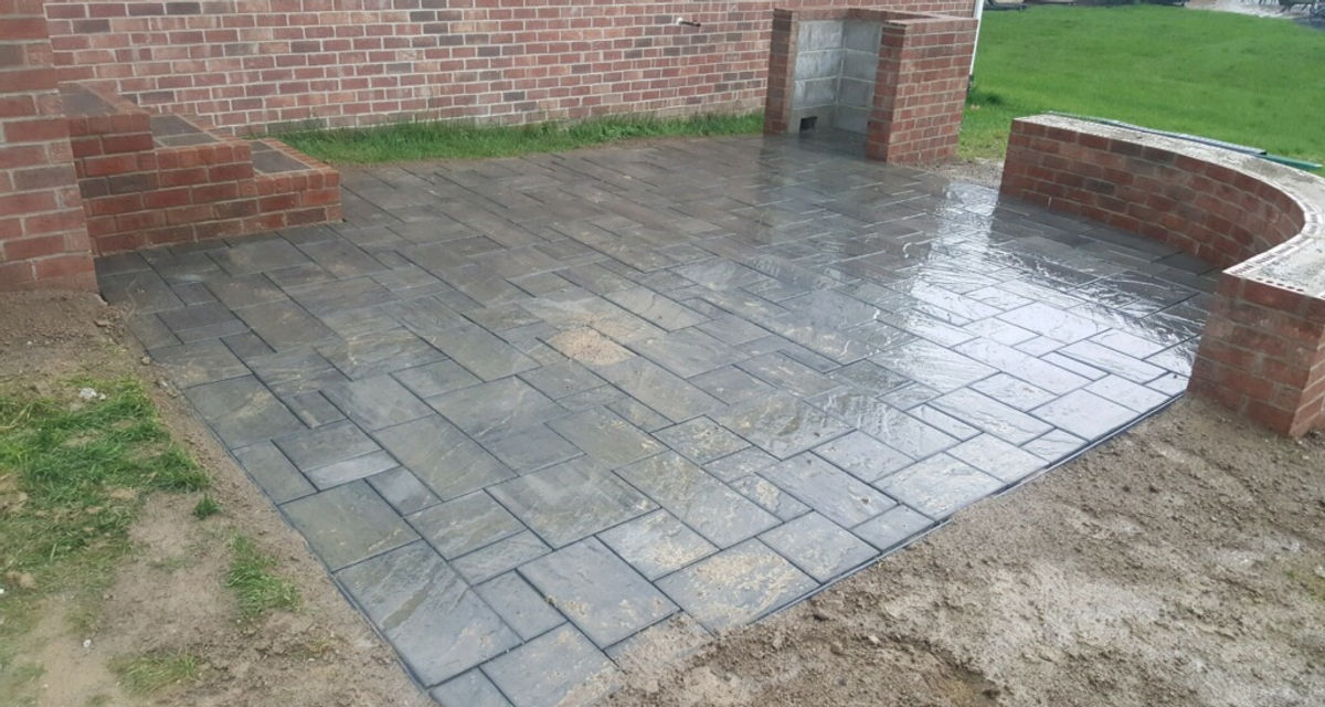 Paver patio with a brick seat wall