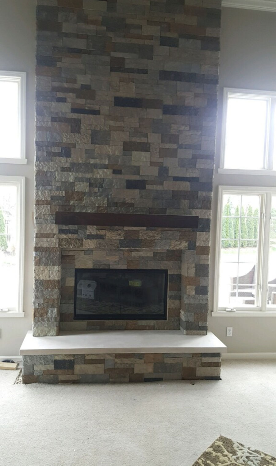 Floor-to-ceiling indoor stone fireplace