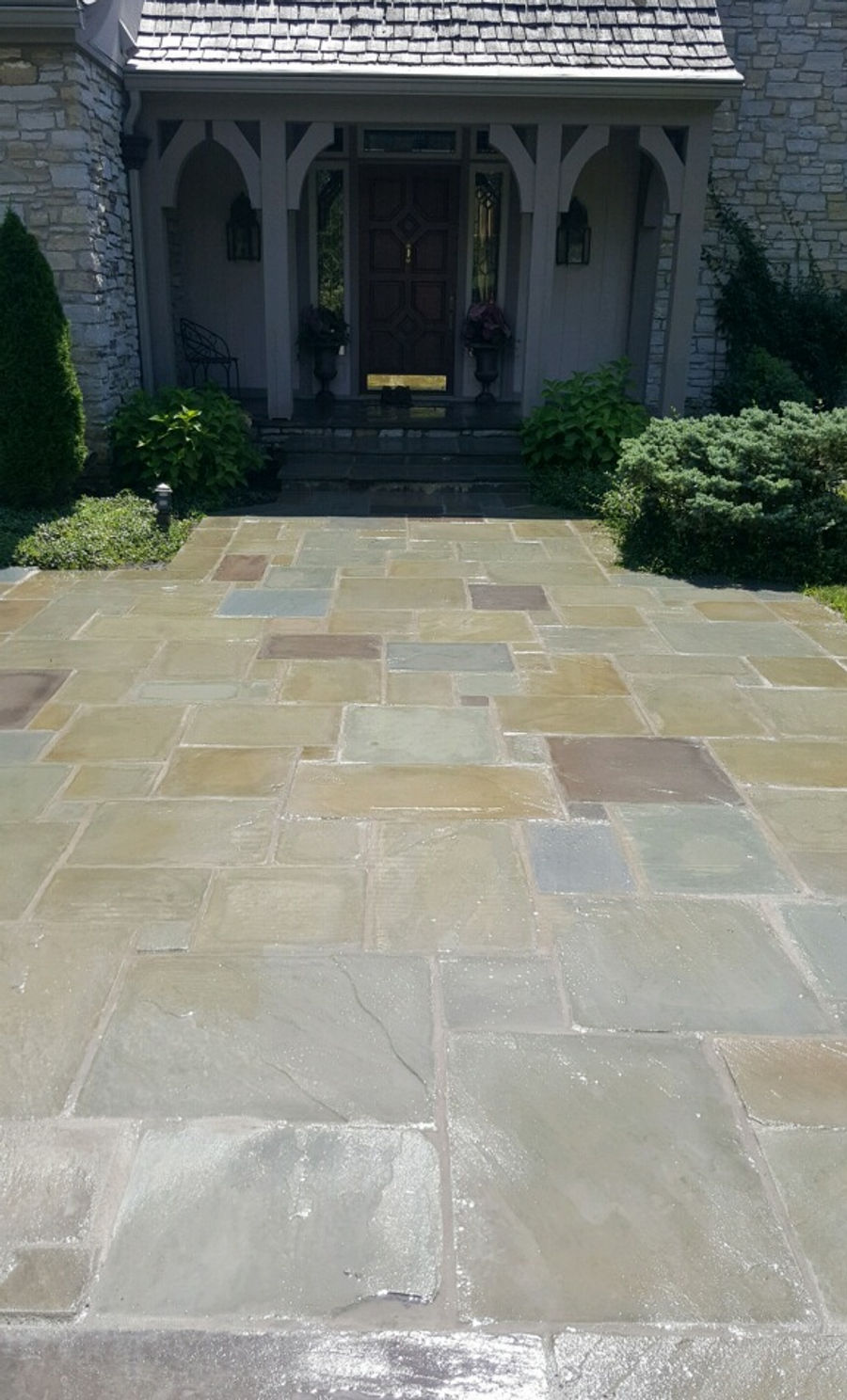 Bluestone walkway leading to an ornate front entry