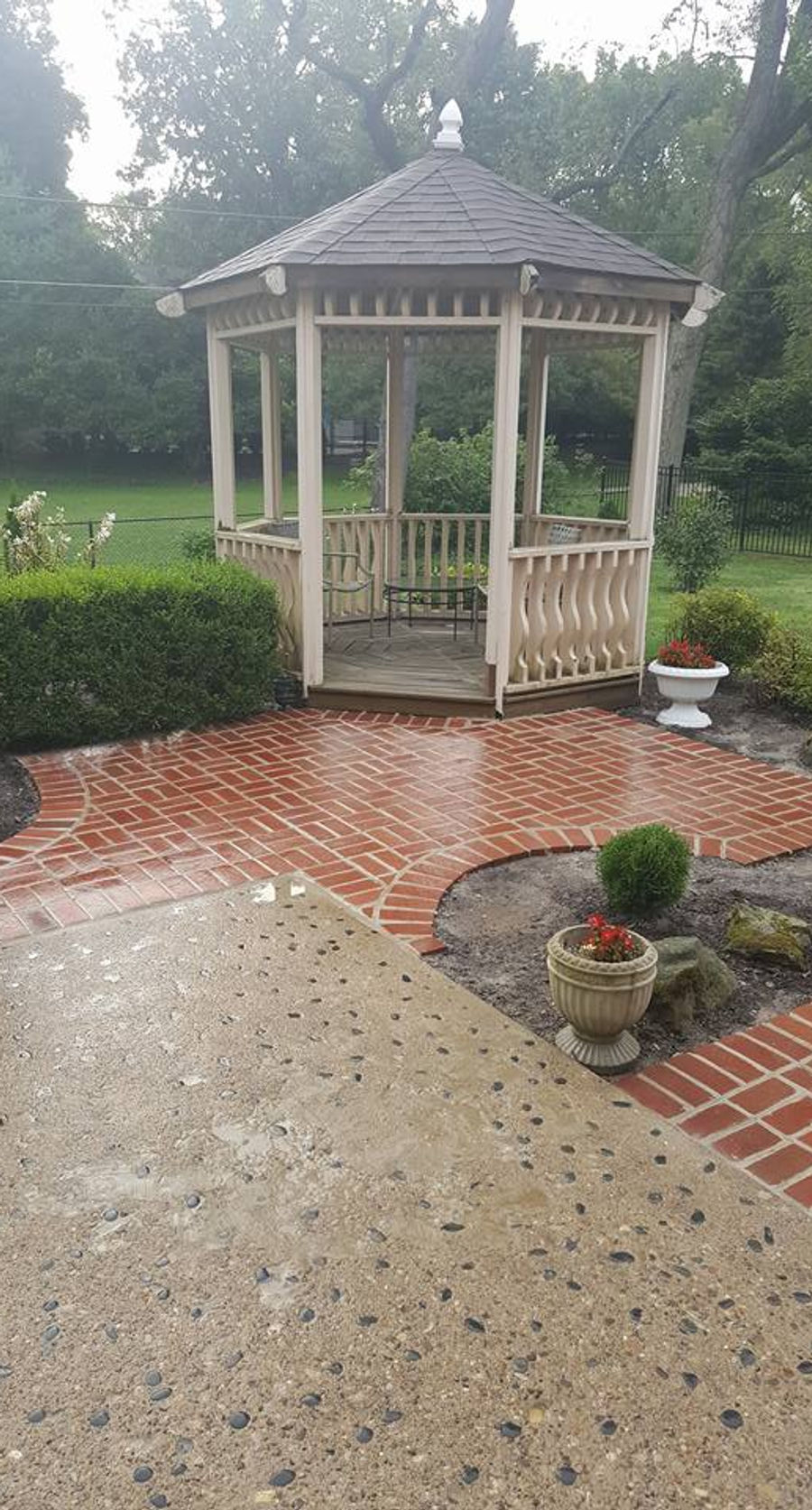 Brick paver path leading to a garden gazebo